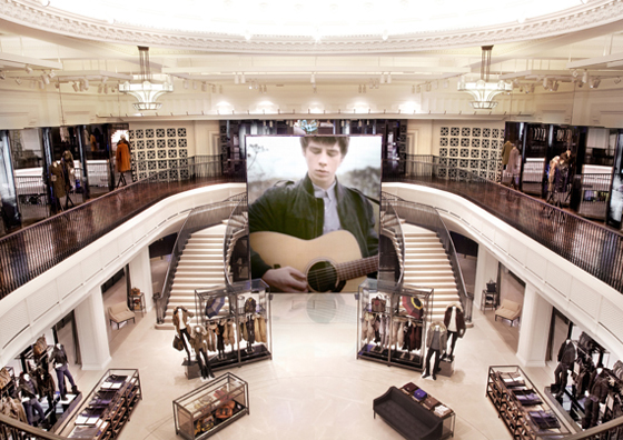 Online communities of fans are invited to become in-house, real-time patrons at Burberry’s new flagship store on London’s Regent Street. Seamlessly integrated digital technology includes a 7-metre-high laser-phosphor screen for live web streaming…
